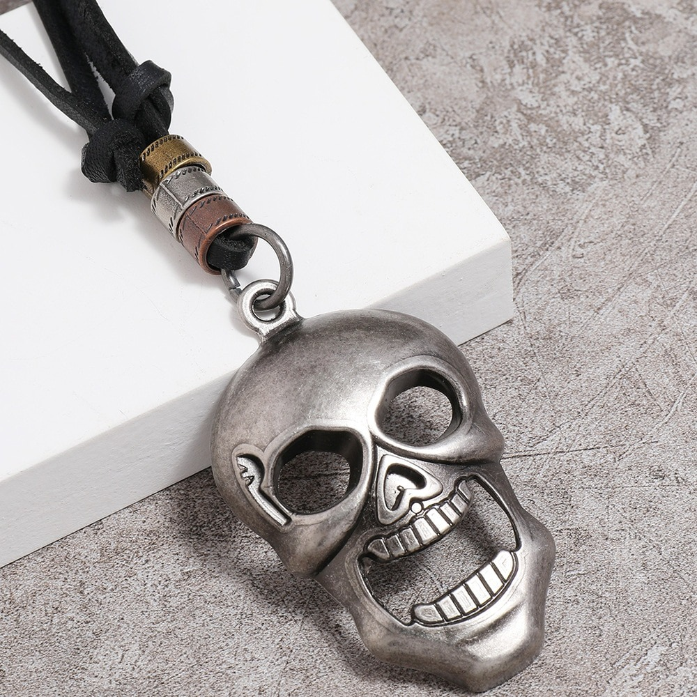 Vintage silver skull pendant necklace on adjustable leather cord, perfect for gothic style enthusiasts.