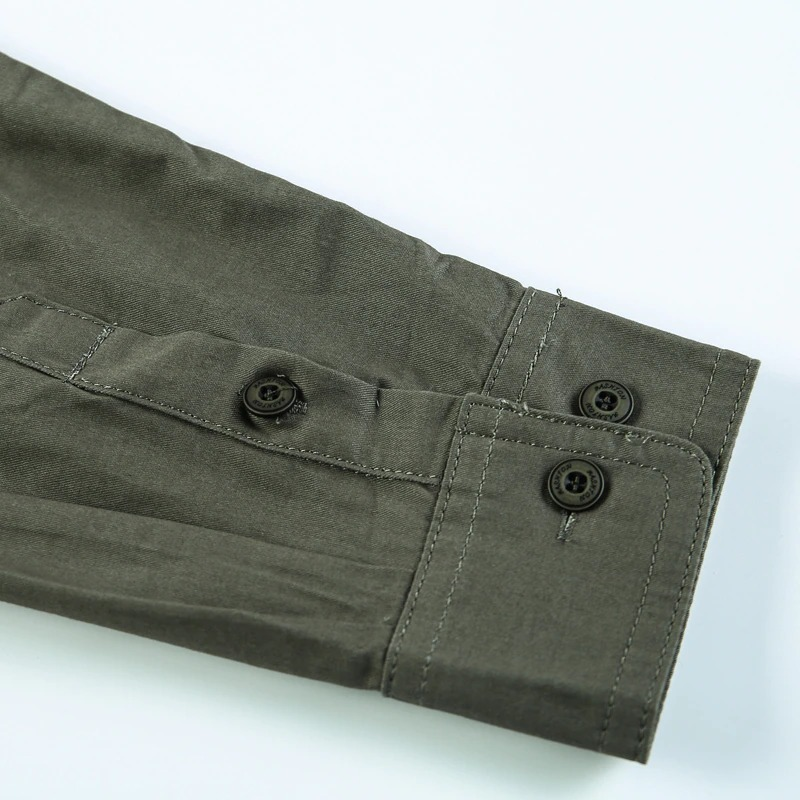 Close-up of the cuff detailing on a military style men's cotton shirt, featuring buttons and a stylish army design.