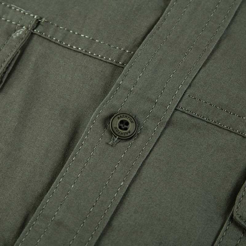 Close-up of a military-style men's cotton shirt with stylish buttons and stitching detail.