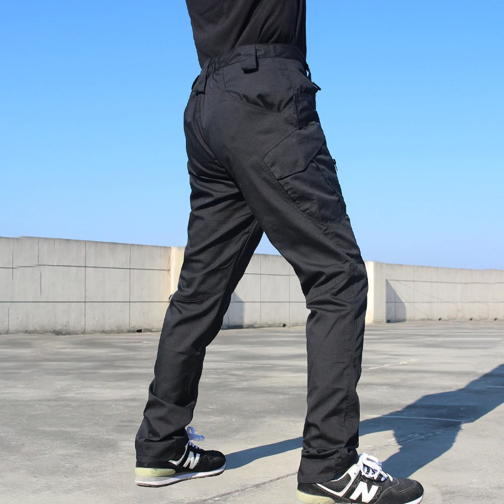 Men's military tactical cargo pants in black, showcasing multiple pockets and stretch cotton fabric.
