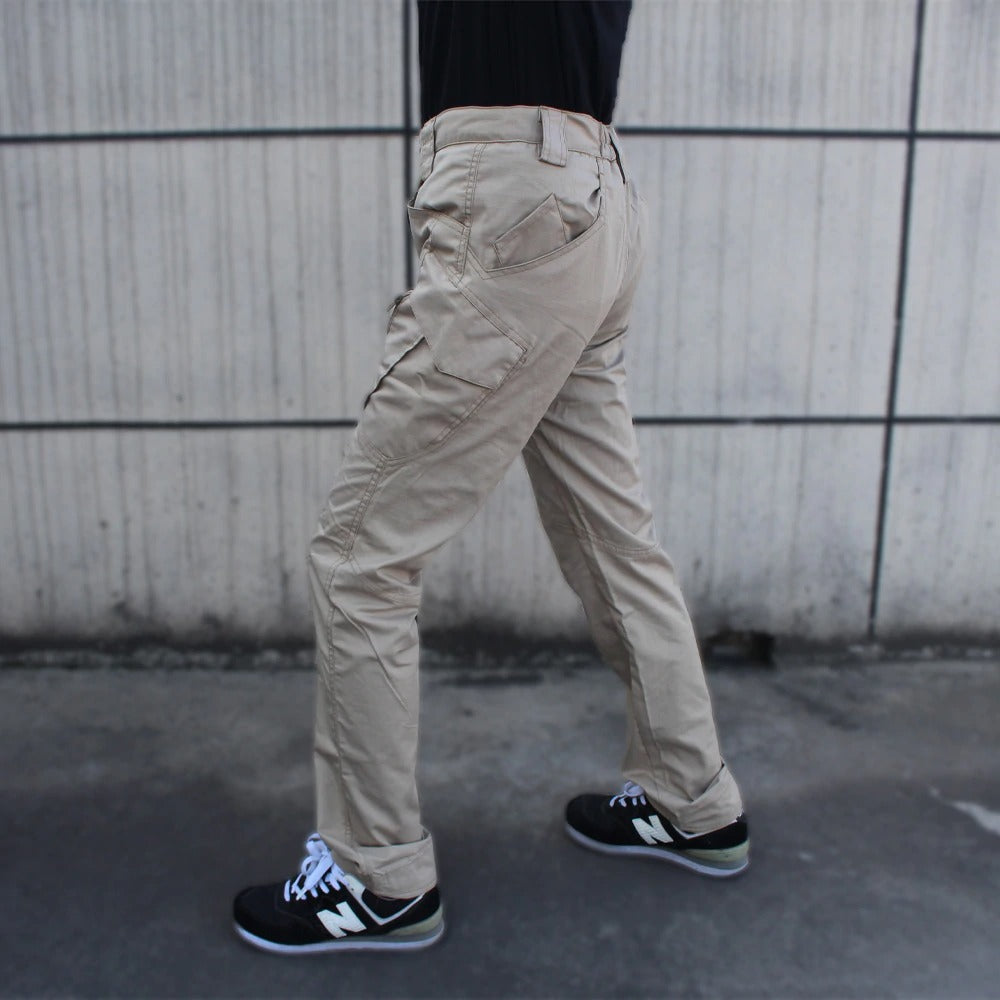 Side view of a person wearing military tactical cargo pants in khaki, showcasing multiple pockets and flexible fit.