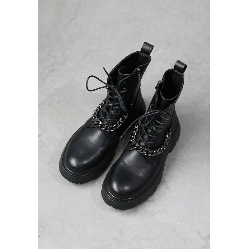 Men's black motorcycle boots with laces and metal chain decoration, stylish thick-soled footwear.