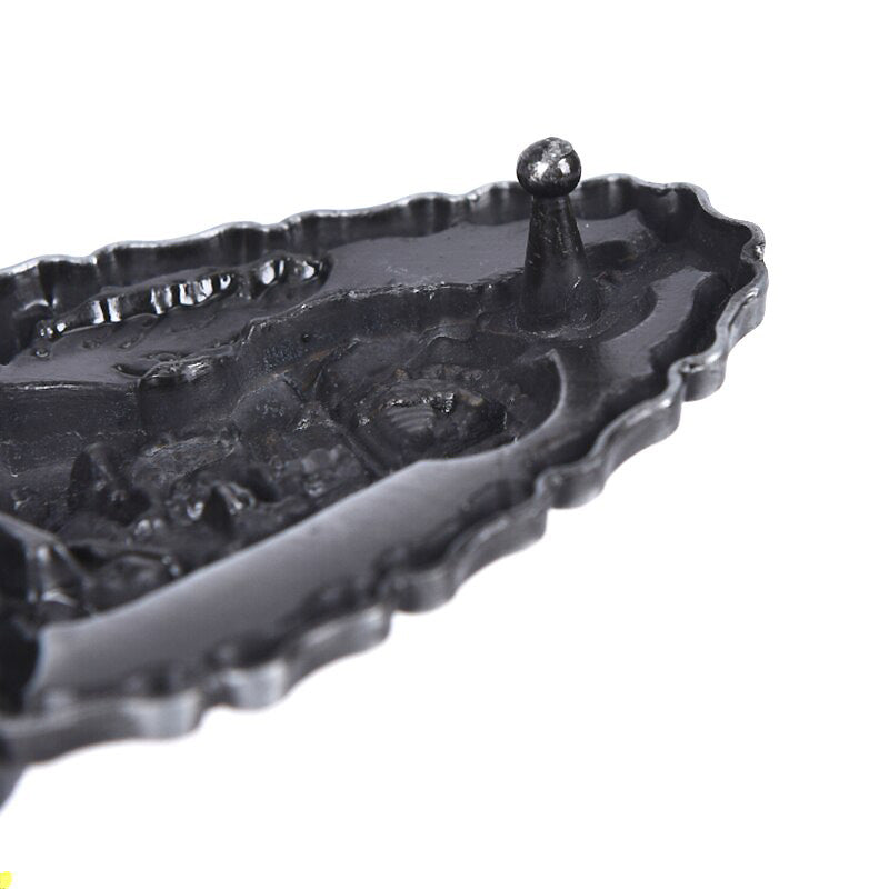 Detailed black motorcycle-shaped metal belt buckle, perfect for bikers and adding style to any outfit.