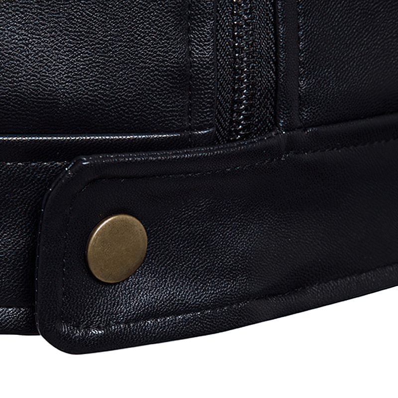 Close-up of black PU leather biker jacket detail showcasing zipper and brass snap button.