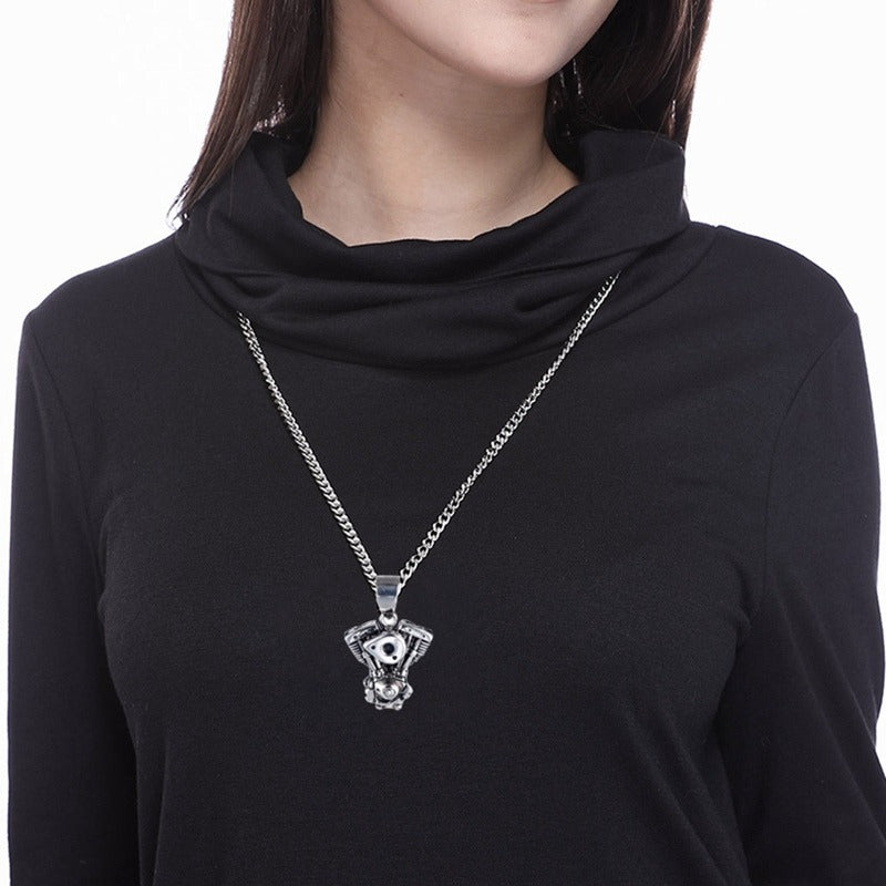 Stylish motorcycle engine pendant necklace worn by a person, perfect for bikers and rock enthusiasts, showcasing stainless steel charm.