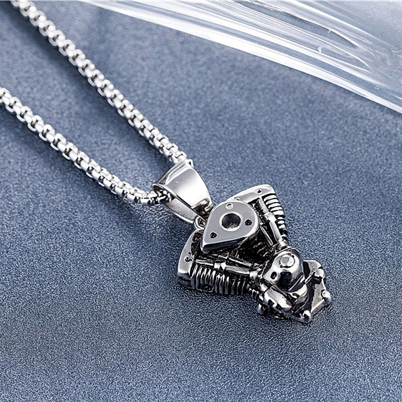 Motorcycle engine pendant necklace made of stainless steel, ideal for bikers and rock lovers.