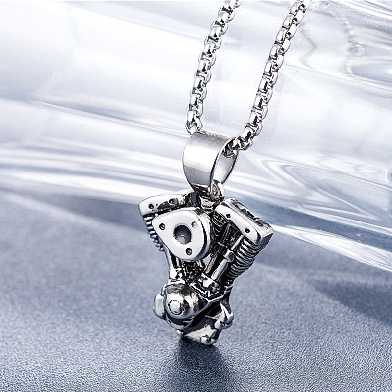 Motorcycle engine pendant necklace in shiny stainless steel, perfect for biker fashion enthusiasts and rock music lovers.