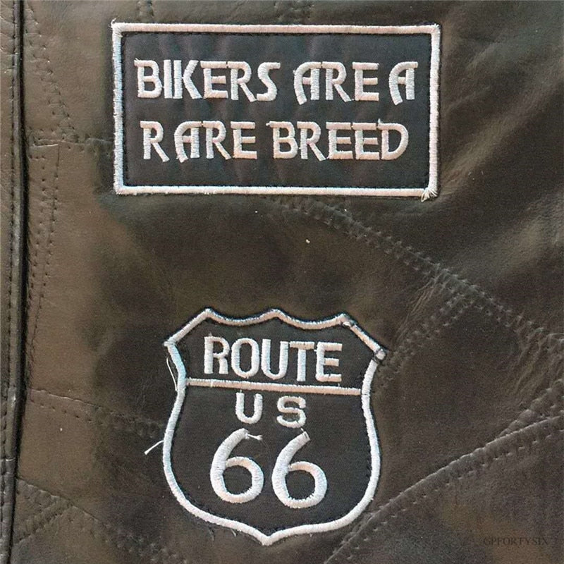 Close-up of biker patches featuring 'Bikers Are a Rare Breed' and 'Route US 66' on leather material.
