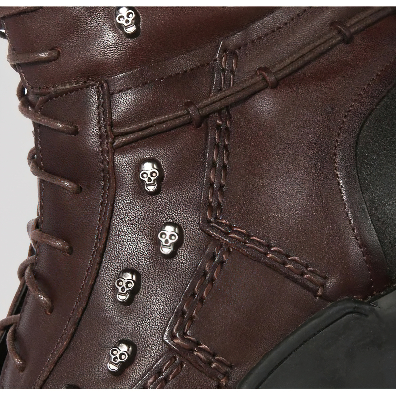 Close-up of men's military combat leather boots with silver skull rivets and stylish lace detailing.