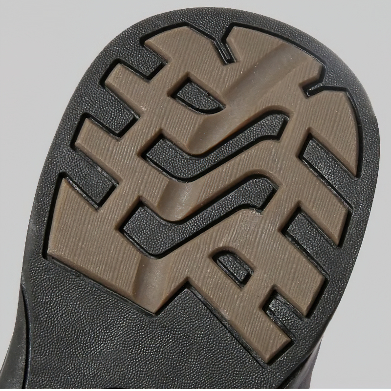 Close-up of the rugged sole of men's genuine leather motorcycle combat boots, showcasing modern tread design.