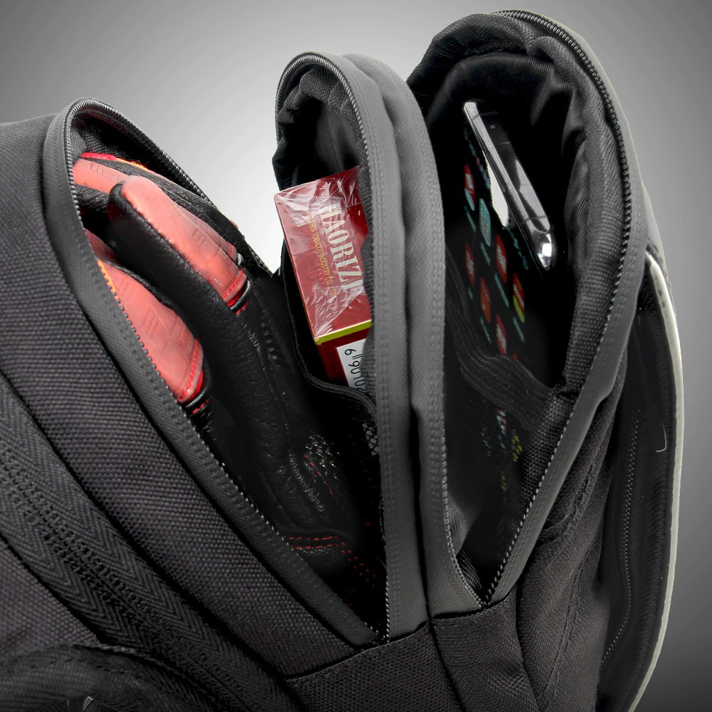Close-up of motorcycle bag interior showing gloves, phone, and pockets for essentials.