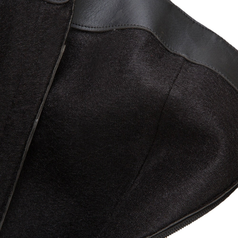 Close-up of the interior lining of women's motorcycle boots showcasing soft black suede and leather design.
