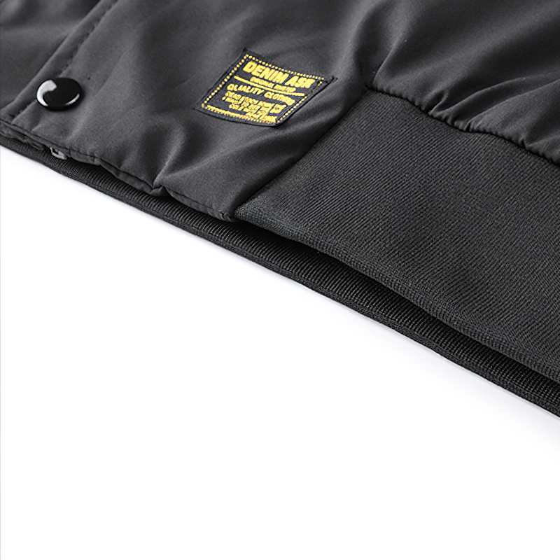 Close-up of the black multi-pocket cargo bomber jacket showcasing quality fabric and label details.