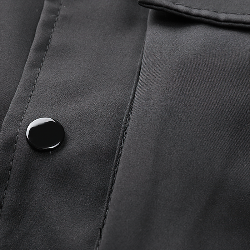 Close-up of black fabric and button detail on multi-pocket cargo bomber jacket for men.