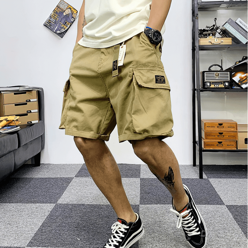 Trendy men's cargo shorts in khaki, featuring multiple pockets and a stylish design for alternative fashion.