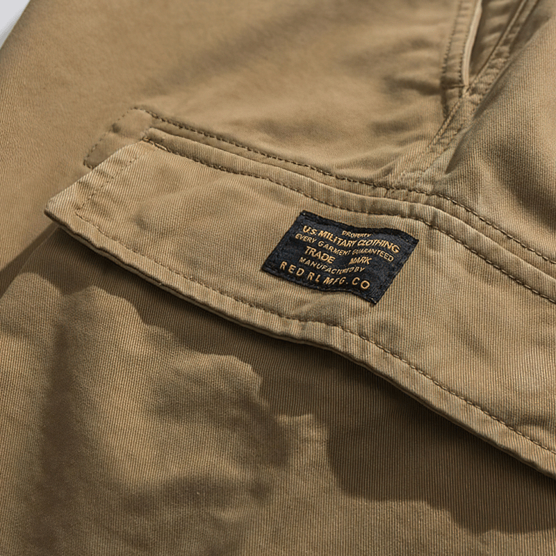 Close-up of cotton cargo shorts label, showcasing quality military-inspired design and branding.