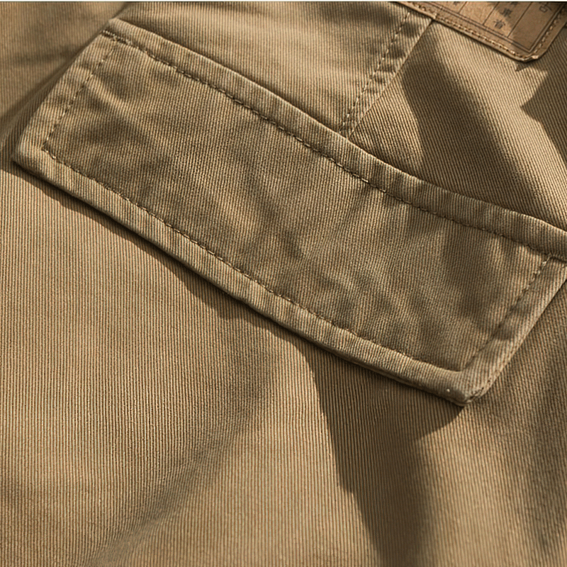 Close-up of quality cotton fabric pocket on men's camouflage cargo shorts, showcasing durability and style.