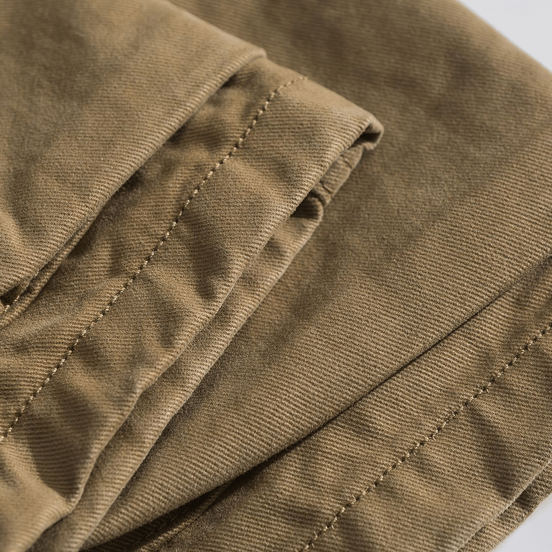Close-up of folded cotton material showcasing the texture of military camouflage cargo shorts.