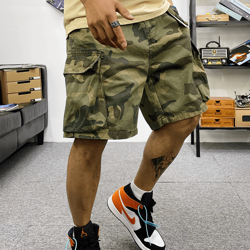 Men's stylish camouflage cargo shorts featuring multiple pockets and a trendy alternative design, perfect for casual outfits.