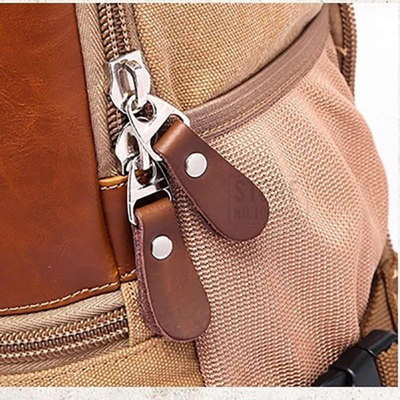Close-up of stylish zippers on a unisex multifunction motorcycle backpack in casual design.