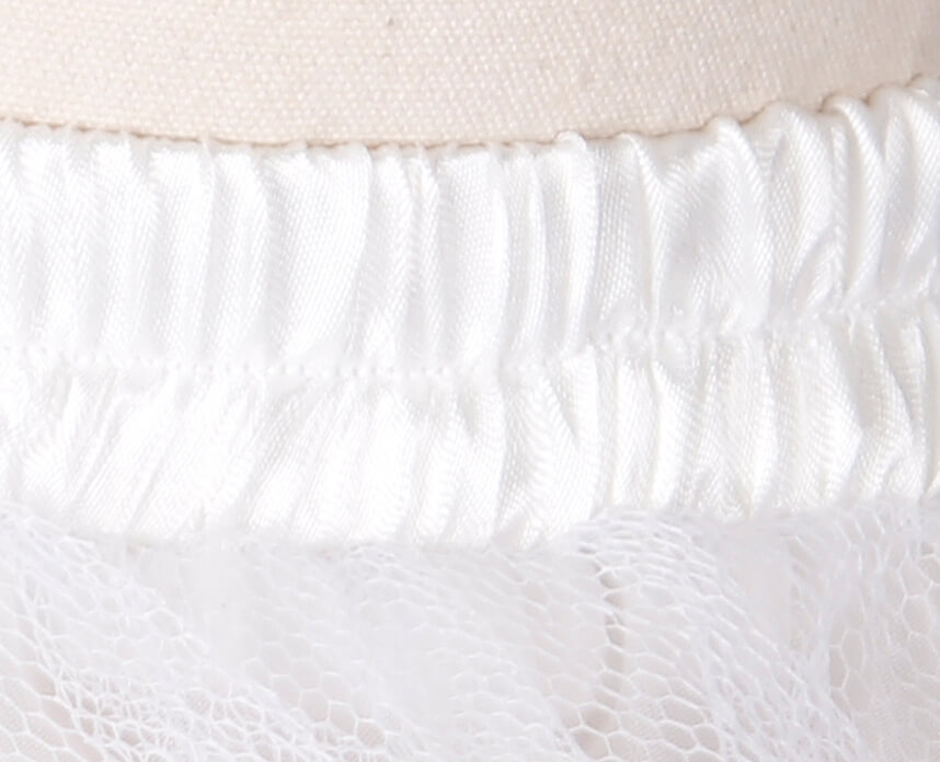 Close-up of the elastic waistband on a multilayer mesh mini skirt in gothic style apparel.
