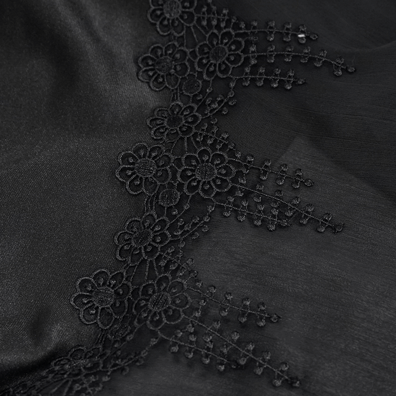 Close-up of black fabric with intricate lace border detailing, perfect for gothic fashion lovers.
