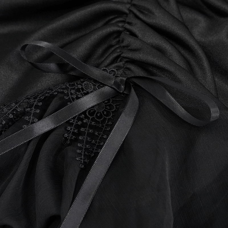 Close-up of black gothic skirt, featuring lace trim and decorative satin ribbon details.