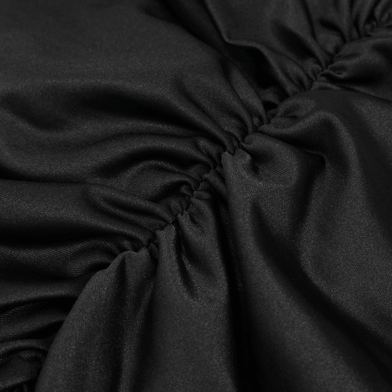 Close-up of smooth black fabric with gathered detail, showcasing elegance and texture perfect for a gothic skirt.