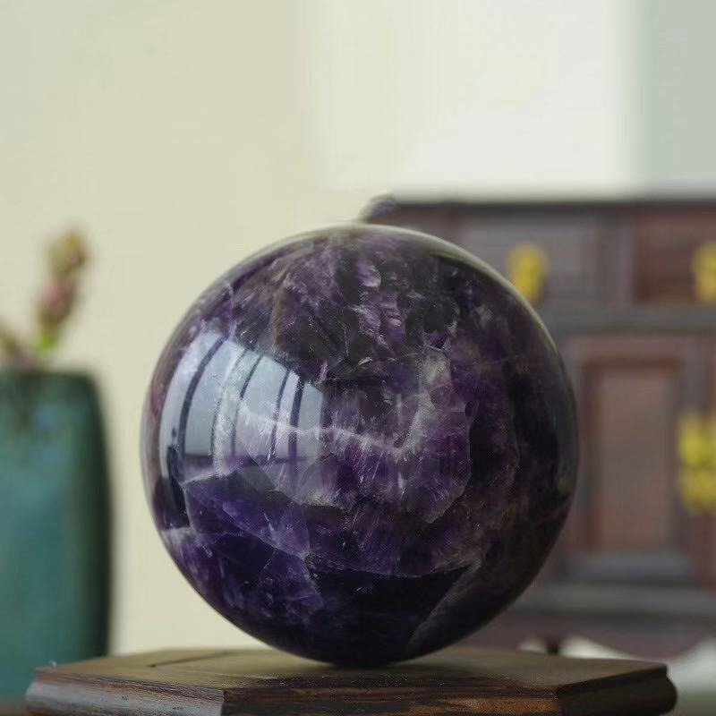 Natural amethyst ball for home decoration, showcasing rich purple colors and stunning mineral details.
