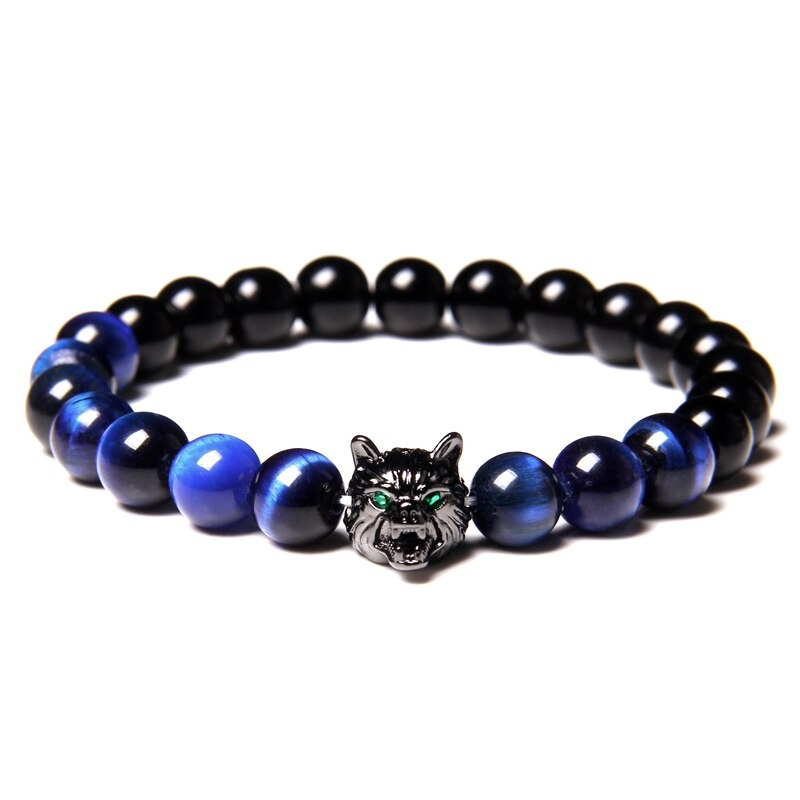 Natural black lava stone bracelet featuring a wolf charm, unique beads in blue and black, perfect for alternative style lovers.