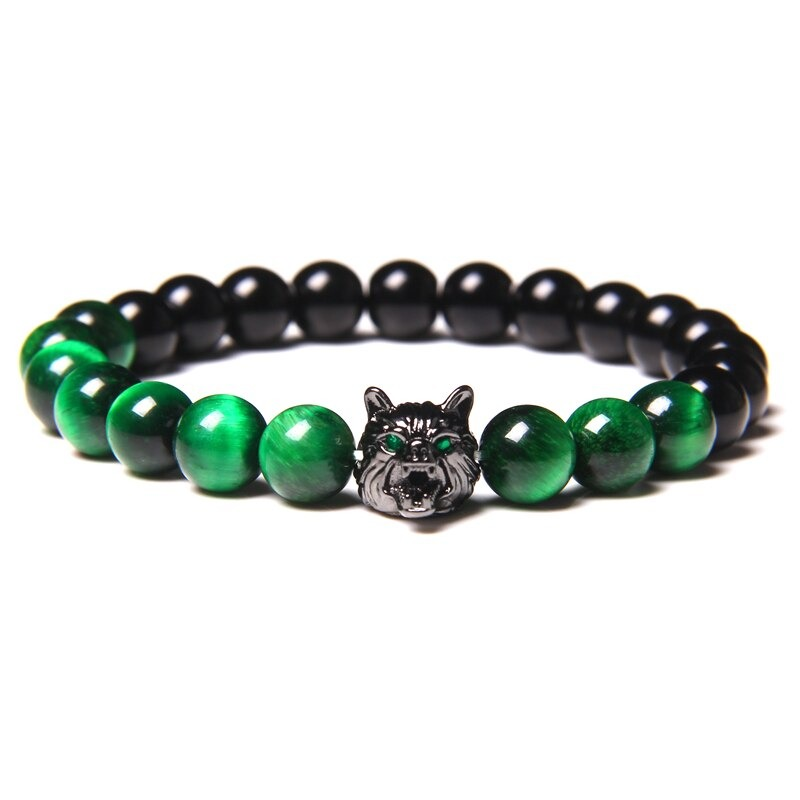 Natural black lava stone bracelet featuring a wolf charm and unique green beads, perfect alternative jewelry.