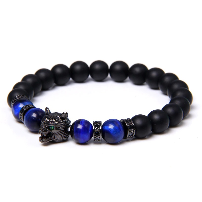 Natural black lava stone bracelet featuring a wolf charm and vibrant blue beads, perfect for alternative style lovers.