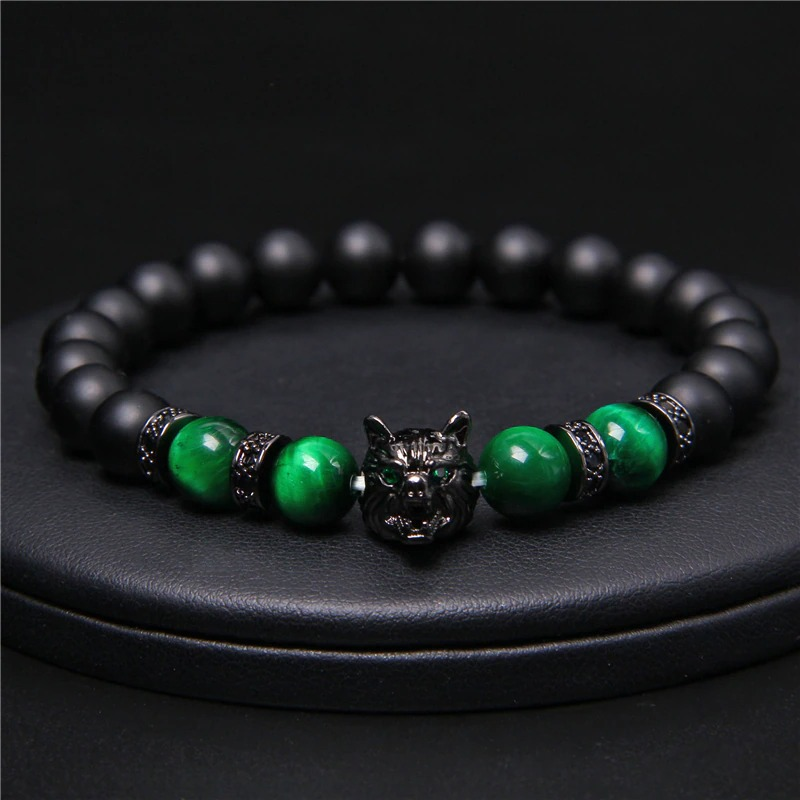 Natural black lava stone bracelet with green beads and wolf charm, perfect alternative jewelry with animal symbol.