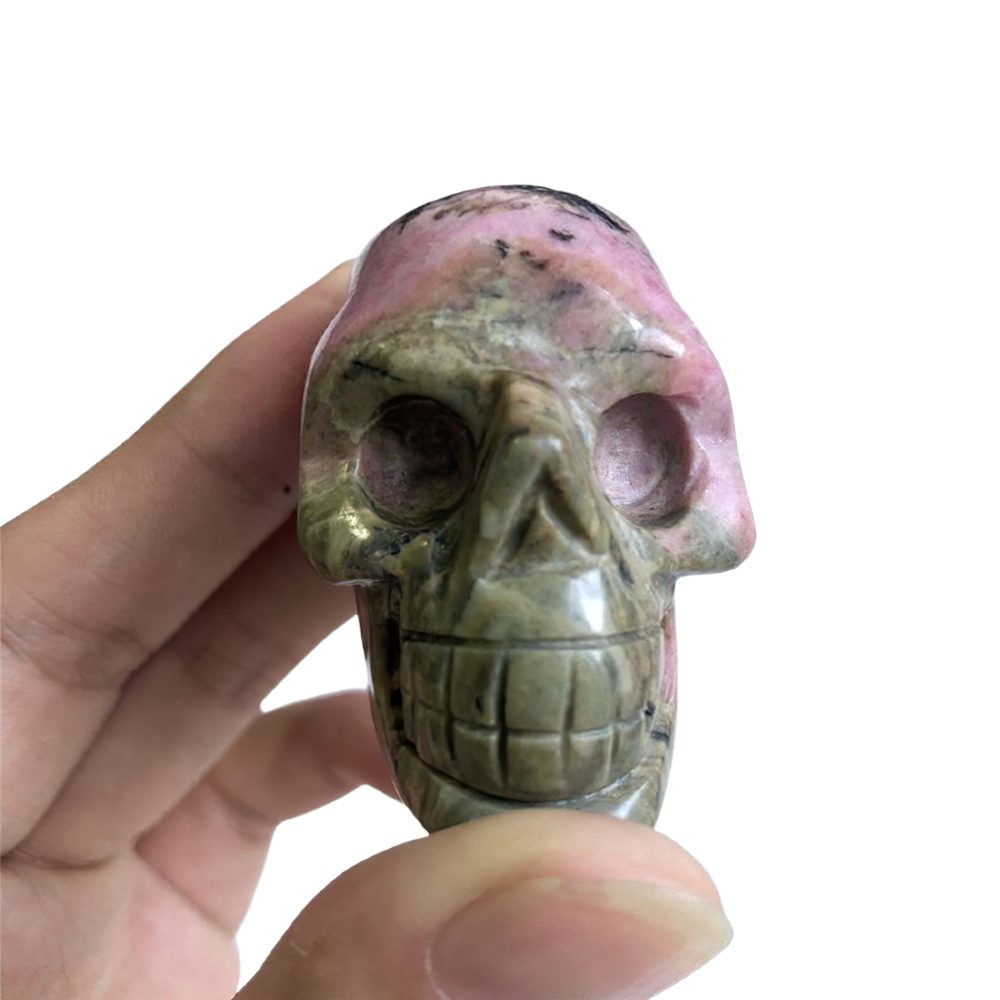 Hand holding a colorful crystal skull, perfect for home decoration and healing energy.