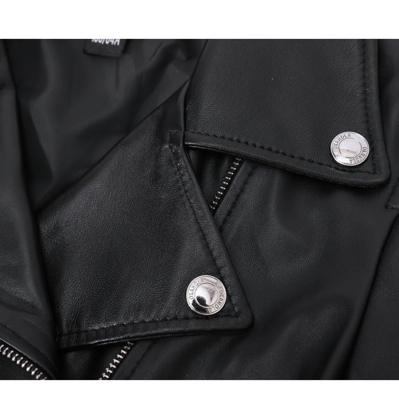 Close-up of a stylish women's sheepskin leather jacket featuring silver zippers and decorative rivets.