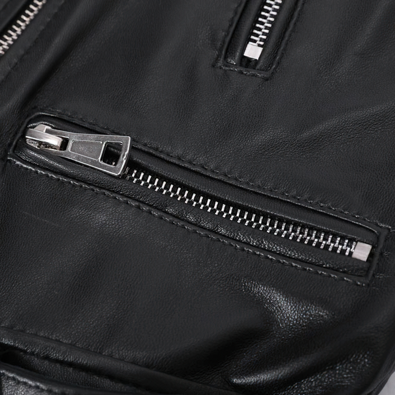 Close-up of stylish silver zippers on a black sheepskin leather jacket, showcasing its trendy details.