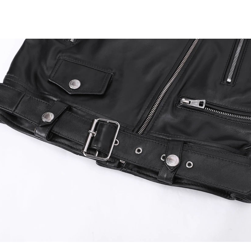 Close-up of a stylish women's sheepskin leather jacket featuring silver zippers, rivets, and a buckle.