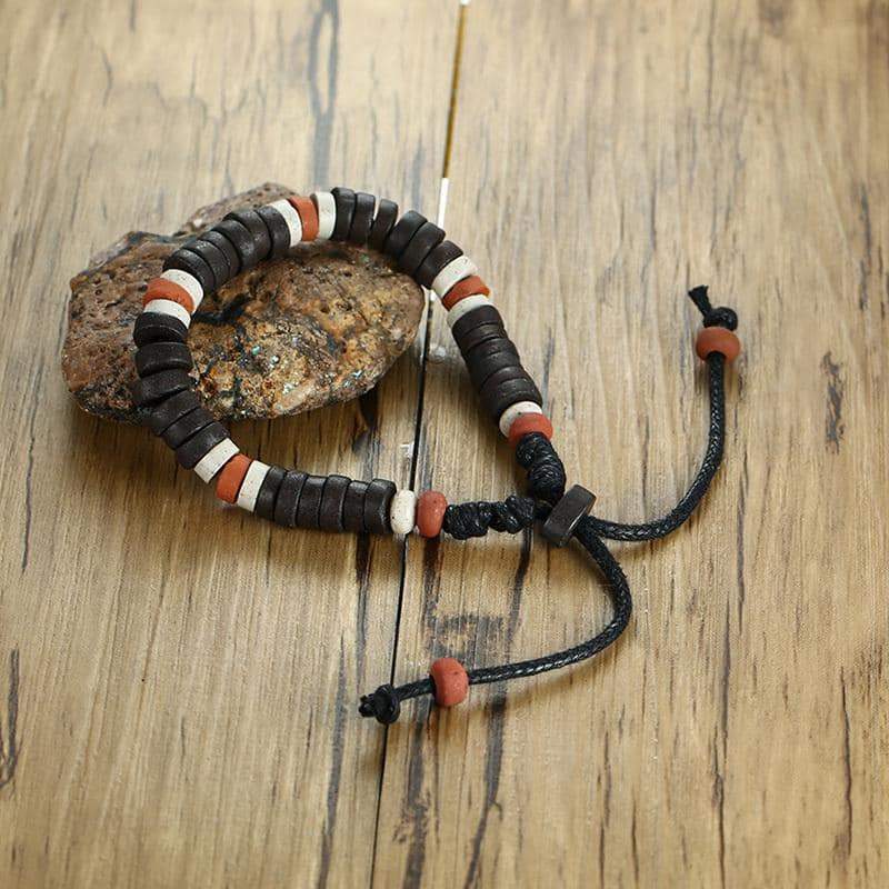 Natural stone beaded bracelet with adjustable length, featuring multicolor beads on a wooden surface.