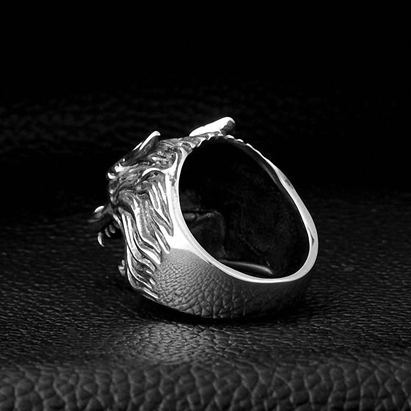 Stainless steel wolf head biker ring showcasing detailed craftsmanship on a black textured background.