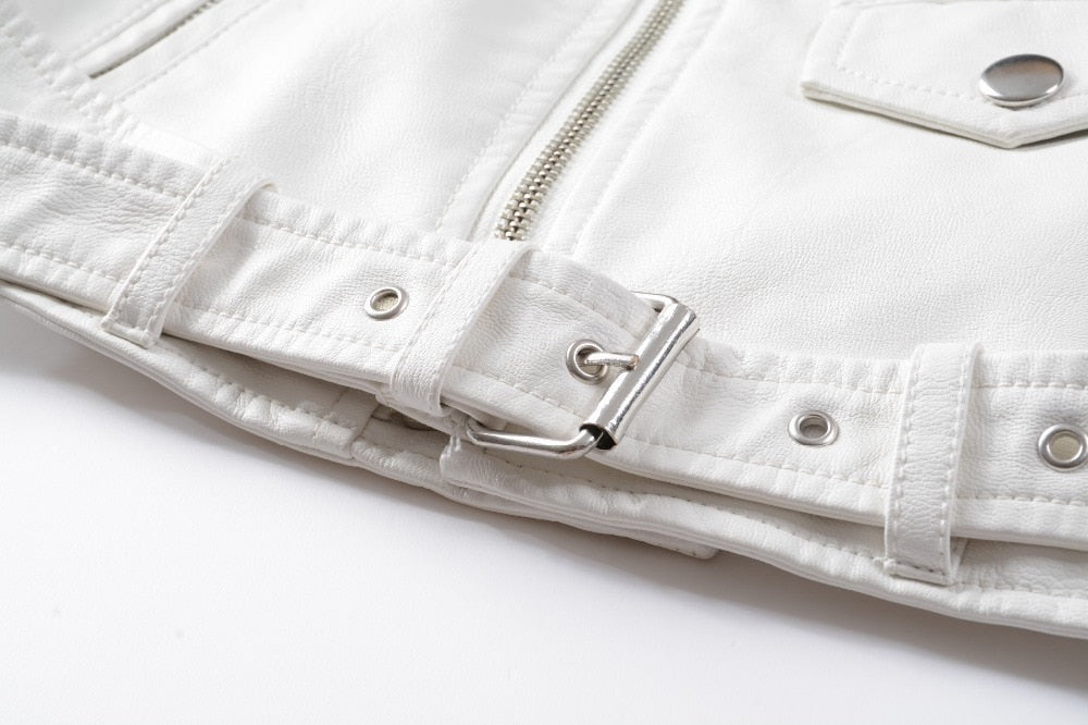Close-up of a white faux leather jacket belt and zipper details, showcasing alternative fashion style.