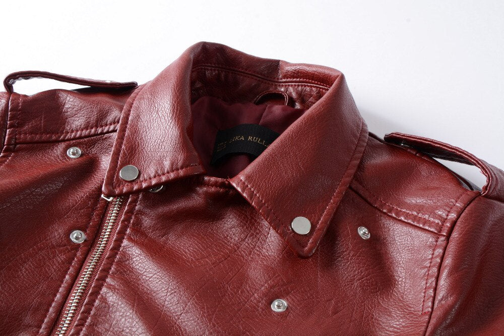 Close-up view of a stylish red faux leather women's motorcycle jacket featuring a snap collar and metallic details.