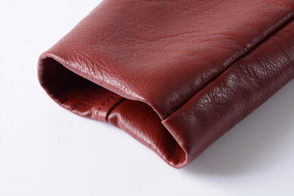Close-up of a soft burgundy faux leather jacket sleeve showcasing the texture and craftsmanship.