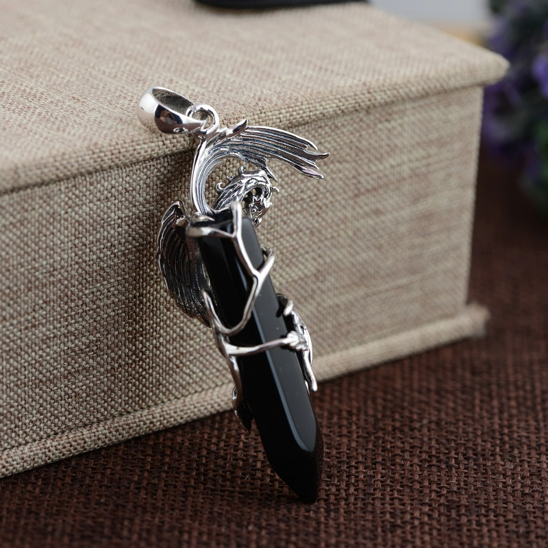 Black stone phoenix pendant with silver wings, showcasing vintage fashion jewelry style.