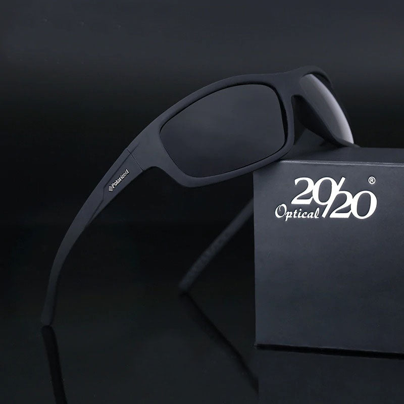 Classic polarized men's sunglasses with black frames resting near a stylish box, perfect for casual outings.