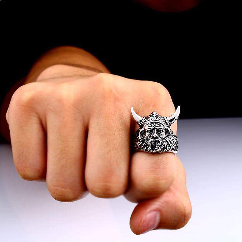 Nordic Viking ring on a hand, showcasing detailed warrior face and horns, perfect for rock and biker styles.