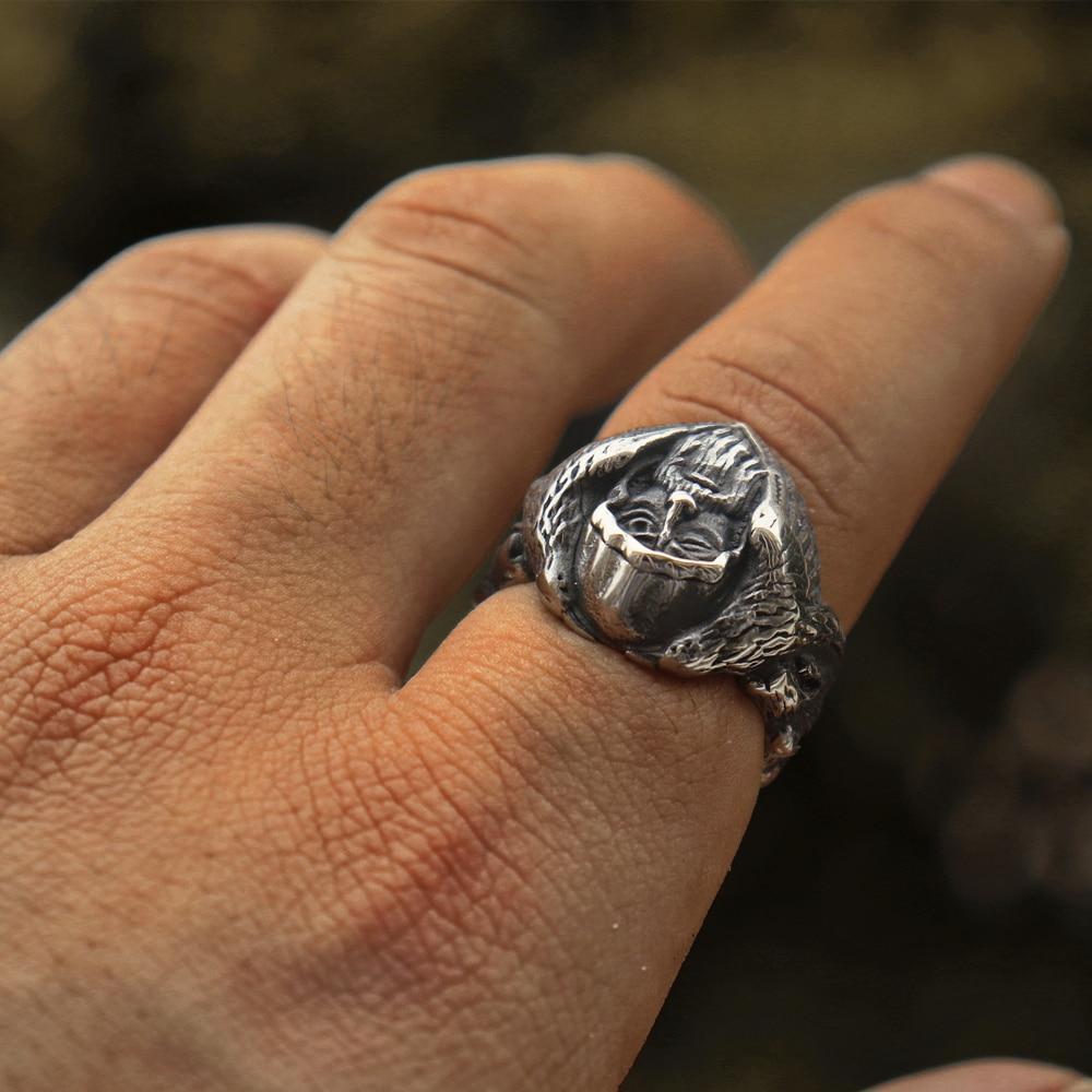 North Mythology Viking Wolf Ring on hand, showcasing intricate details of a man's face and eagles in stainless steel finish.