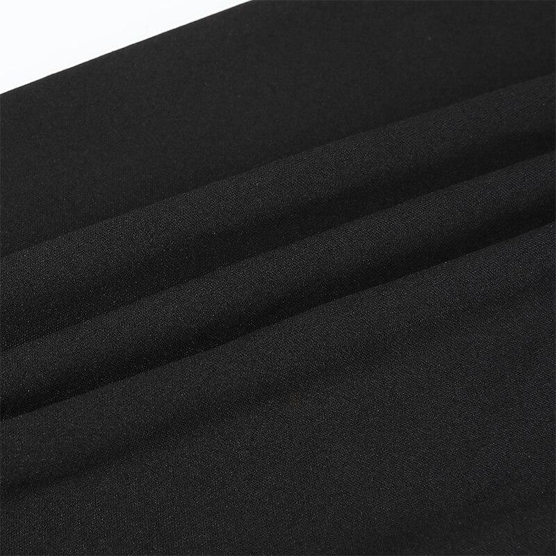 Close-up of soft black fabric featuring elegant folds, perfect for alternative fashion clothing like off-shoulder tops.