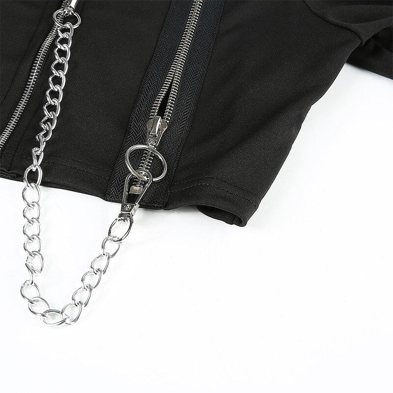 Close-up of black off-shoulder female top with silver zippers and chain detailing for alternative rock style fashion.