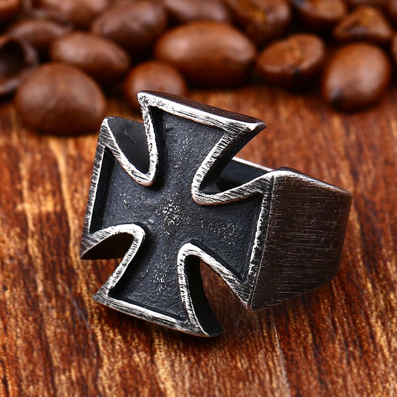 Old School Biker Iron Cross Ring on wood, surrounded by coffee beans, showcasing unisex stainless steel rock style.