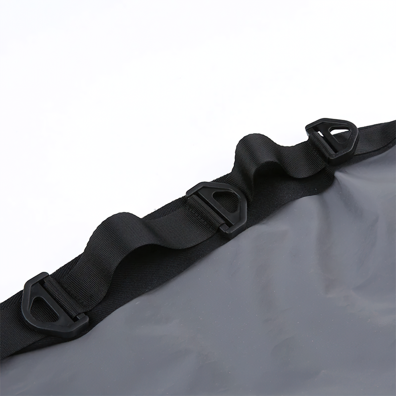 Close-up of adjustable black straps and clips on a clear waterproof bag, perfect for outdoor adventures.